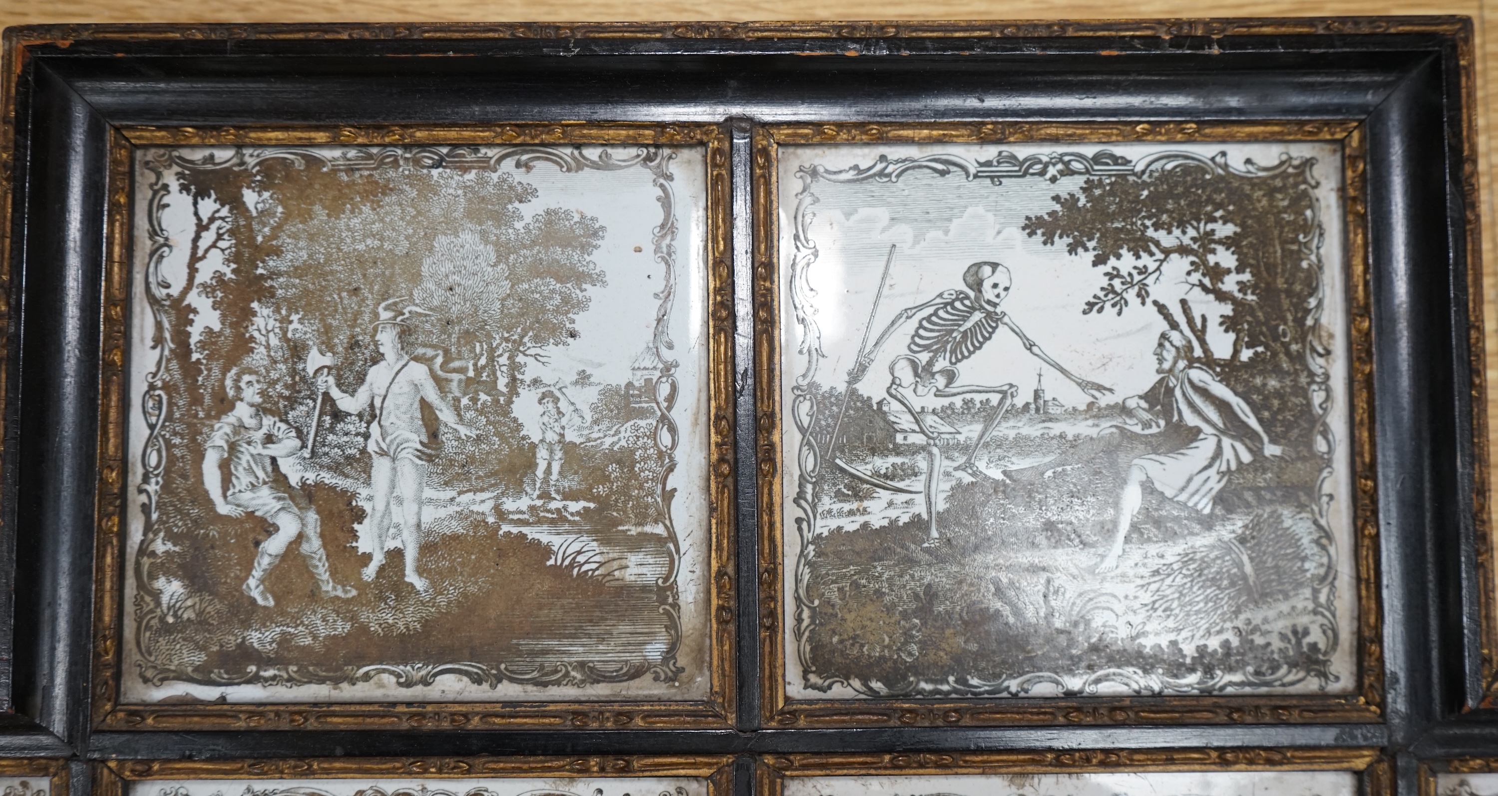 A framed set of six 18th century Liverpool delftware black and white printed tiles, Aesop’s Fables by Sadler, 57cm wide. Condition - fair